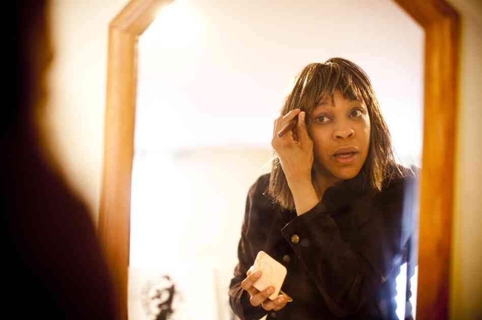 Natasha applies makeup to "get the tired out of my face." She credits her faith with allowing her to manage the stress of being a caregiver.