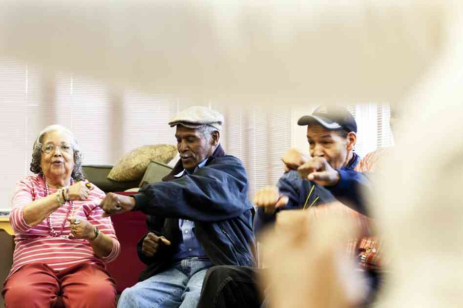 Franklin (center) makes a punching movement in a self-defense exercise during his Tai Chi class.