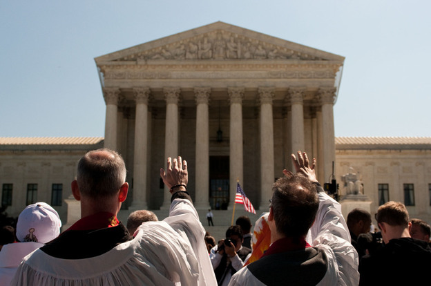 A group dressed in robes parades in silence around the Supreme Court building in a Bible-inspired "Jericho Walk."