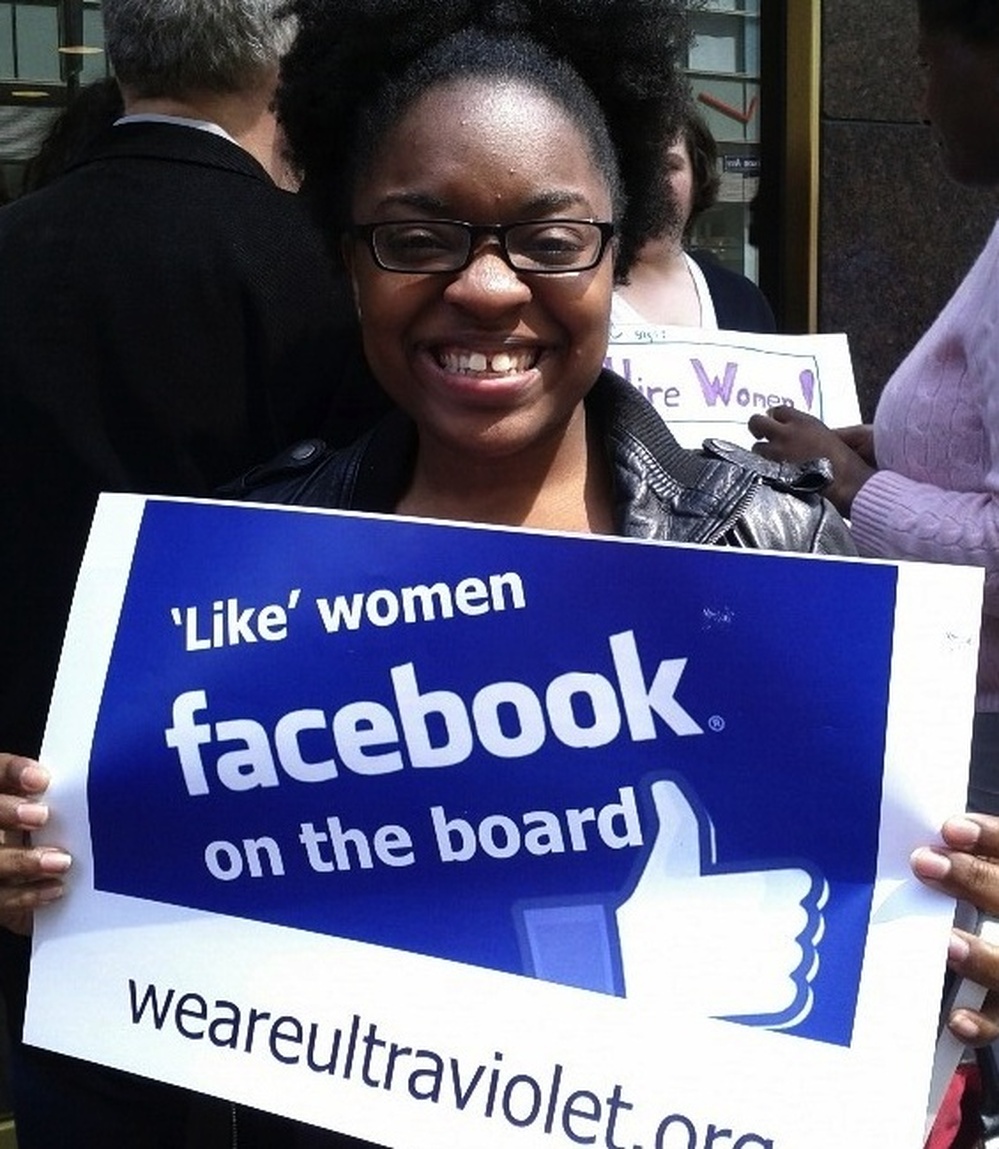 A protester holds a sign in front of Facebook's New York offices.