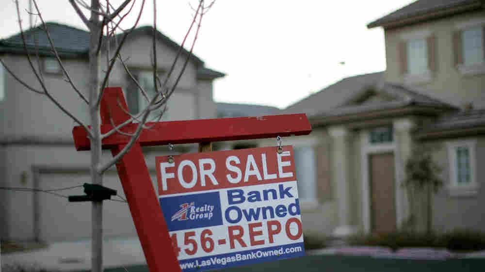 A sign stands in front of a bank-owned home in Las Vegas. Housing counselors say the $25 billion mortgage settlement between major banks and the states has yet to make an impact in communities around the U.S. A sign stands in front of a bank-owned home in Las Vegas. Housing counselors say the $25 billion mortgage settlement between major banks and the states has yet to make an impact in communities around the U.S.