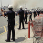 Los Angeles police form a line to keep a crowd from entering a building on April 30, 1992. Twenty years after the L.A. riots, most civil rights and community groups give the LAPD high marks for progress.