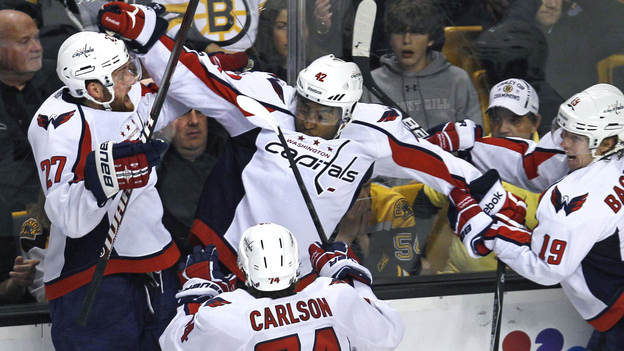 Washington Capitals right wing Joel Ward, center, is mobbed by teammates after his game-winning goal against the Boston Bruins.