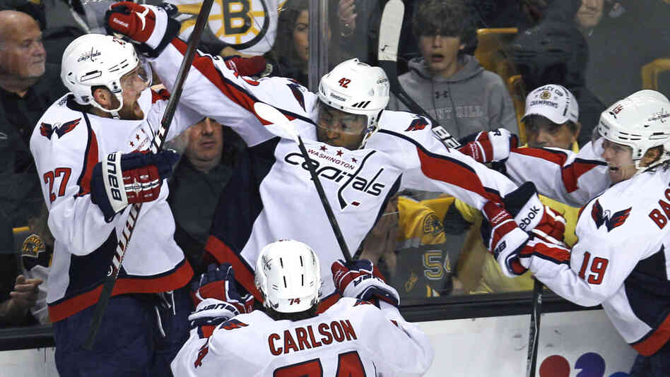 Washington Capitals right wing Joel Ward, center, is mobbed by teammates after his game-winning goal against the Boston Bruins.