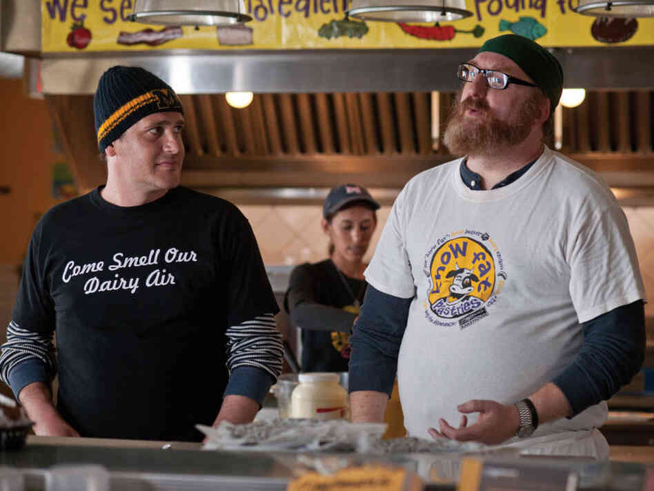 Tom makes the best of the relocation by making unlikely friends like Tarquin (Brian Posehn) and trying to find work as a chef — while in the meantime putting in time at Ann Arbor's famed Zingerman's Deli. Tom makes the best of the relocation by making unlikely friends like Tarquin (Brian Posehn) and trying to find work as a chef — while in the meantime putting in time at Ann Arbor's famed Zingerman's Deli.
