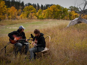 Martha Scanlan performs with Jon Neufeld in a meadow at the ranch where she works.