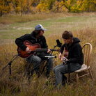 Martha Scanlan performs with Jon Neufeld in a meadow at the ranch where she works.