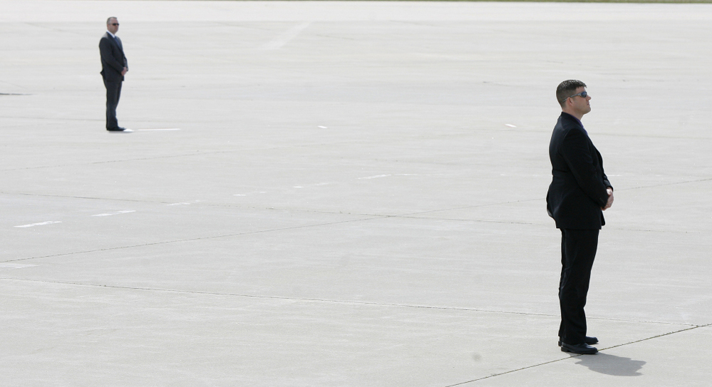 Secret Service agents awaited the arrival of President Obama in Air Force One at Eastern Iowa Airport in Cedar Rapids, Iowa.