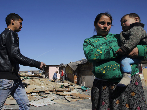 Residents of Cañada Real stand near recently demolished shacks on March 5. The settlement is separated into different sections and tends to be segregated by ethnic groups: Roma in one section, Arabs in another, for example.