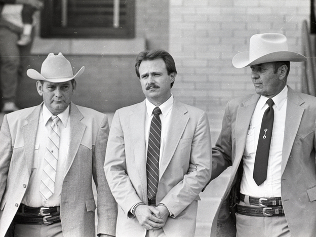 Michael Morton is taken back to jail in February 1987 by Sgt. Don Wood (left) and Sheriff Jim Boutwell (right) after he was convicted of his wife's murder.