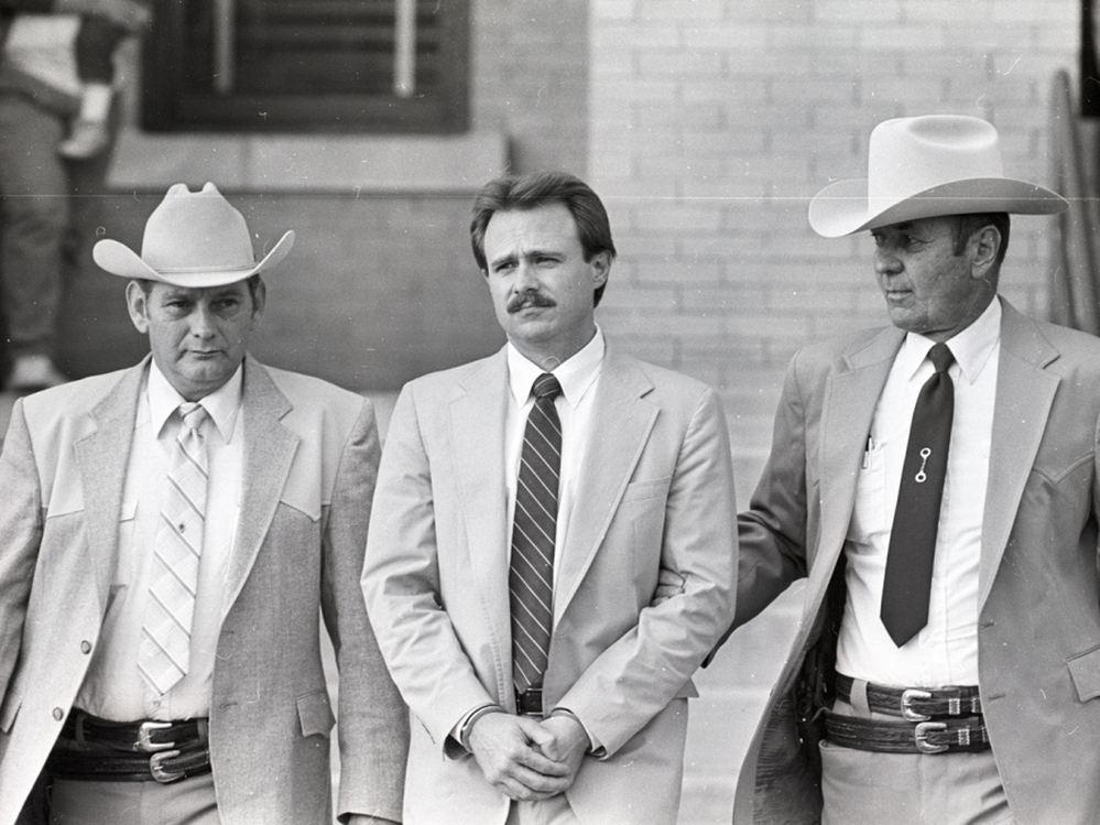 Michael Morton is taken back to jail in February 1987 by Sgt. Don Wood (left) and Sheriff Jim Boutwell (right) after he was convicted of his wife's murder.