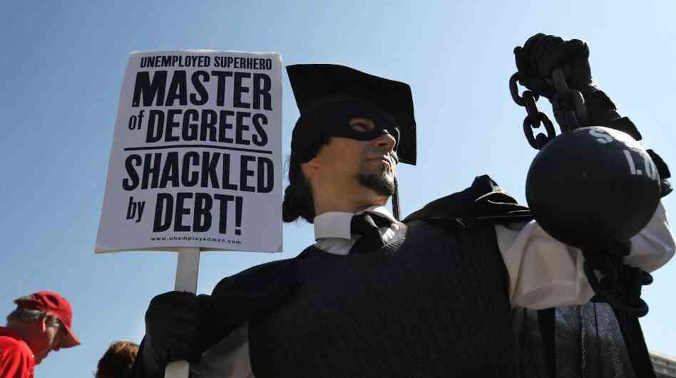 Gan Golan of Los Angeles, dressed as the "Master of Degrees," holds a ball and chain representing his college loan debt during Occupy D.C. activities in Washington. Average in-state tuition and fees at four-year public colleges rose an additional $631 this fall, or 8.3 percent, compared with a year ago.
