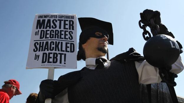 Gan Golan of Los Angeles, dressed as the "Master of Degrees," holds a ball and chain representing his college loan debt during Occupy D.C. activities in Washington. Average in-state tuition and fees at four-year public colleges rose an additional $631 this fall, or 8.3 percent, compared with a year ago.