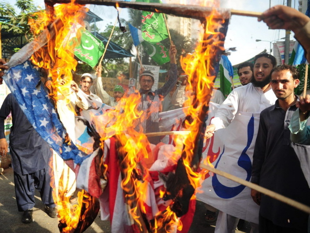 April 13: In Karachi, activists from the Shabab-e-Milli group set fire to U.S. flags during a protest against the reopening of the NATO supply route to Afghanistan.