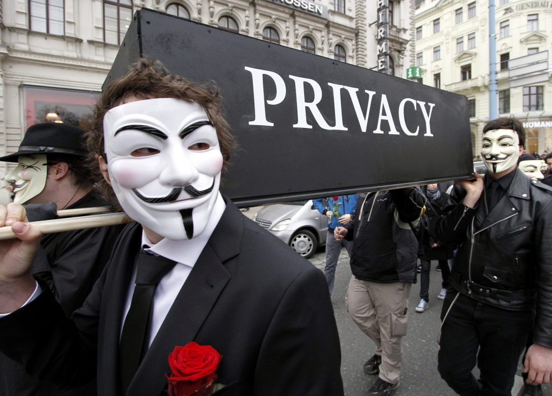 Demonstrators with Guy Fawkes masks protest changing privacy policies on March 31, in Vienna.
