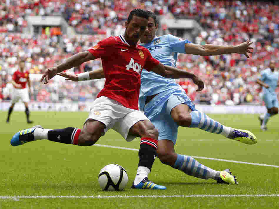 Manchester United's Nani (in red) and Manchester City's Aleksandar Kolarov during a game last August in London.