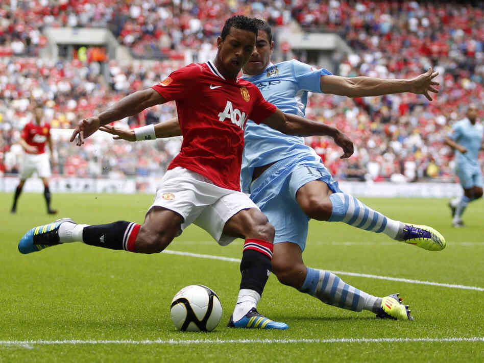 Manchester United's Nani (in red) and Manchester City's Aleksandar Kolarov during a game last August in London.