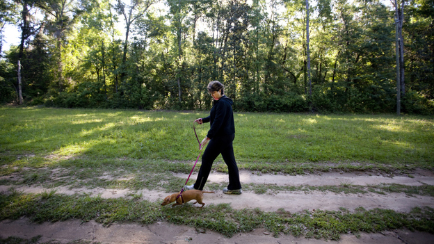 Teresa MacBain walks her dog, Gracie, at a park near her Tallahassee, Fla., home. After a lifetime in the church, MacBain came out as an atheist at an American Atheists' convention in Bethesda, Md.