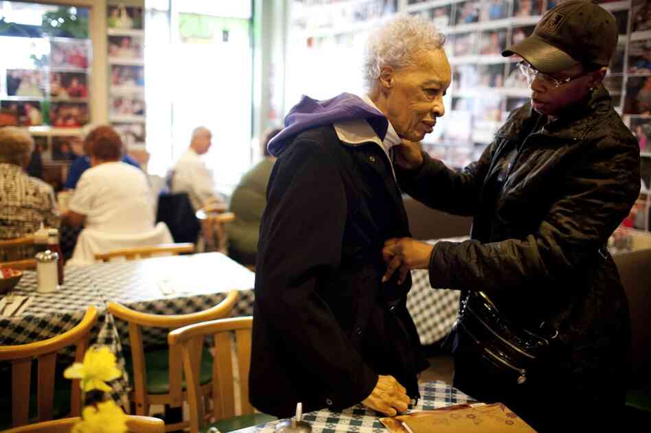 Yolanda zips up Ida's coat after taking her out to breakfast on her 89th birthday.
