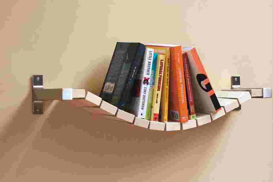 Rope Bridge Bookshelf: "Most bookshelves require bookends to keep the books up," says designer Ed Lewis, "but I thought that a more relaxed approach would keep them all pushed to the middle, thus the Rope Bridge Bookshelf."