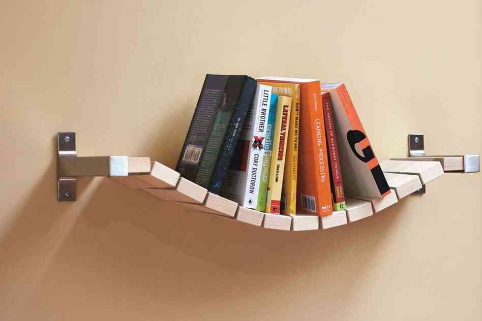 Rope Bridge Bookshelf: "Most bookshelves require bookends to keep the books up," says designer Ed Lewis, "but I thought that a more relaxed approach would keep them all pushed to the middle, thus the Rope Bridge Bookshelf."