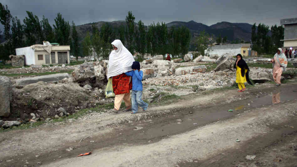 Pakistanis walk past the rubble of the demolished compound of slain al-Qaida leader Osama bin Laden in the northern town of Abbottabad this week. Bin Laden's legacy in Pakistan appears mixed. Support for al-Qaida seems to be down, but bin Laden is still revered by extremists. Pakistanis walk past the rubble of the demolished compound of slain al-Qaida leader Osama bin Laden in the northern town of Abbottabad this week. Bin Laden's legacy in Pakistan appears mixed. Support for al-Qaida seems to be down, but bin Laden is still revered by extremists.