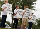 People hold signs during a small April rally in Sanford, Fla., that was billed as an opportunity to show support for the constitutional rights of George Zimmerman and Trayvon Martin. People hold signs during a small April rally in Sanford, Fla., that was billed as an opportunity to show support for the constitutional rights of George Zimmerman and Trayvon Martin.