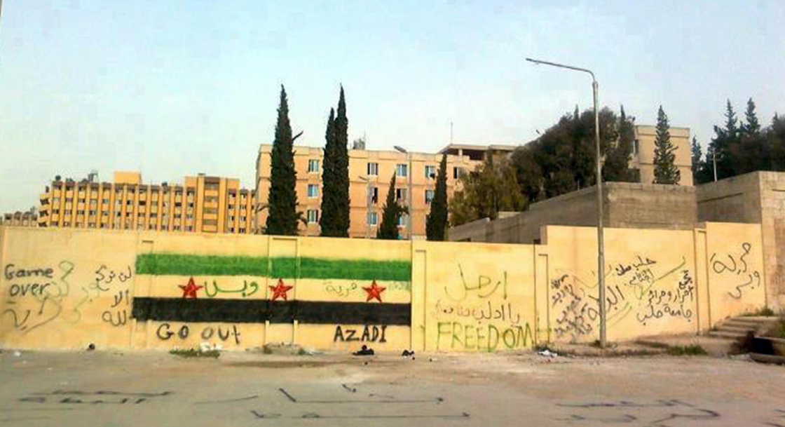 A handout picture released by the Syrian opposition's Shaam News Network shows anti-regime graffiti sprayed on the walls of Aleppo University.