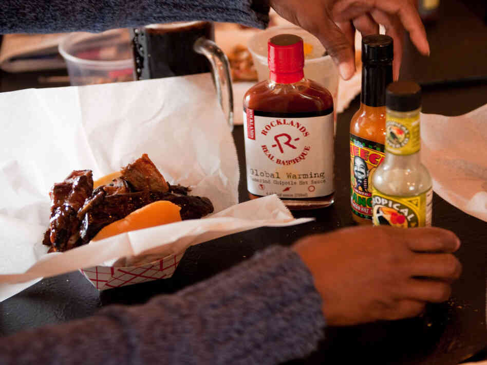 Tami Franklin tries a variety of hot sauces on her barbecue ribs at Rocklands Barbeque and Grilling Company in Arlington, Va. Tami Franklin tries a variety of hot sauces on her barbecue ribs at Rocklands Barbeque and Grilling Company in Arlington, Va.