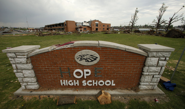 In this photo taken June 14, 2011, a damaged sign for Joplin High School (transformed into "hope" with tape) is seen in front of the school. The school was one of three in the city destroyed by an EF-5 tornado that wiped out much of the community.