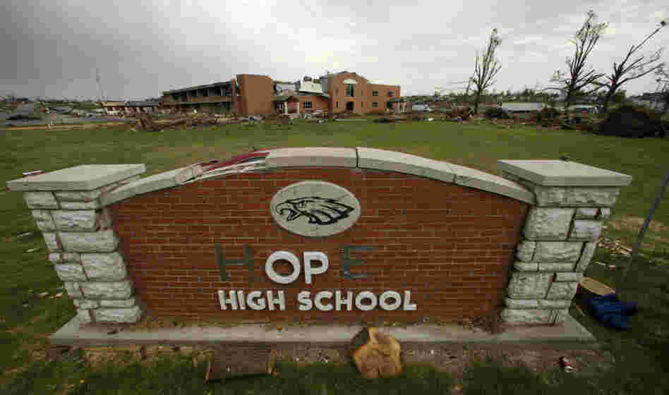 In this photo taken June 14, 2011, a damaged sign for Joplin High School (transformed into "hope" with tape) is seen in front of the school. The school was one of three in the city destroyed by an EF-5 tornado that wiped out much of the community.