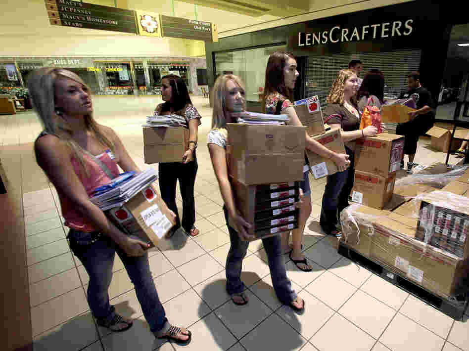 Students carry donated supplies to a classroom on the first day of school at a temporary high school in a converted big-box store in Joplin, Mo., last August. School started on time in the district nearly three months after an EF-5 tornado devastated much of the city and killed 161 people.