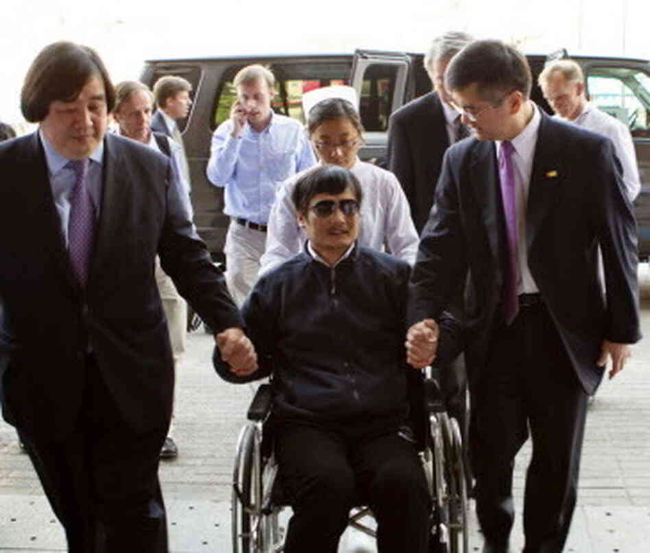 Chinese activist Chen Guangcheng (in wheelchair) held the hand of Gary Locke (at right) the U.S. ambassador to China in Beijing as he arrived at a hospital in Beijing on Wednesday. Chinese activist Chen Guangcheng (in wheelchair) held the hand of Gary Locke (at right) the U.S. ambassador to China in Beijing as he arrived at a hospital in Beijing on Wednesday.