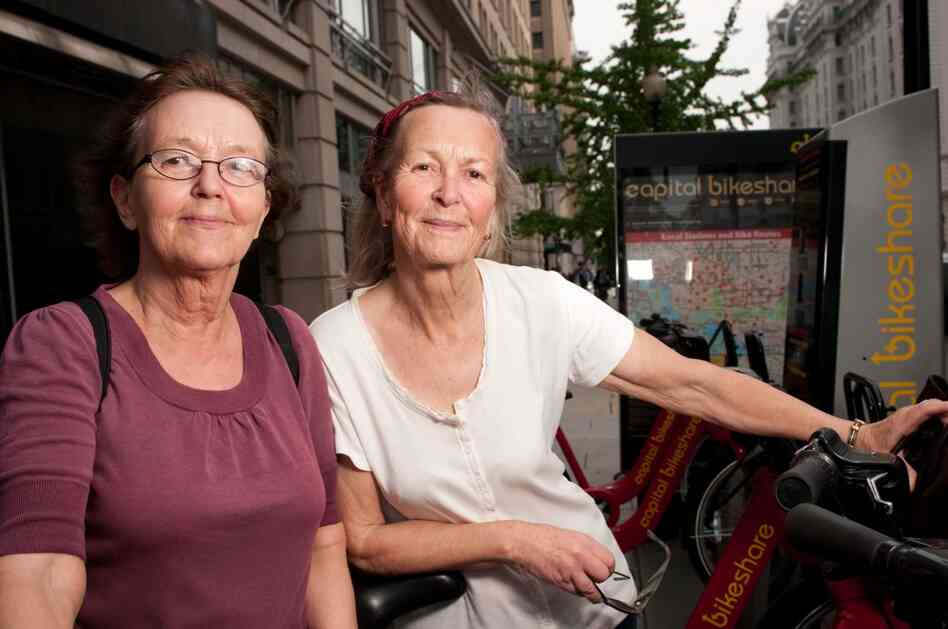 Sisters Bia and Cia Rosenquist are from Finland and Belgium, where helmetless riding is common. "We bike very carefully," Bia says. "We were riding more slowly because we don't know the city."