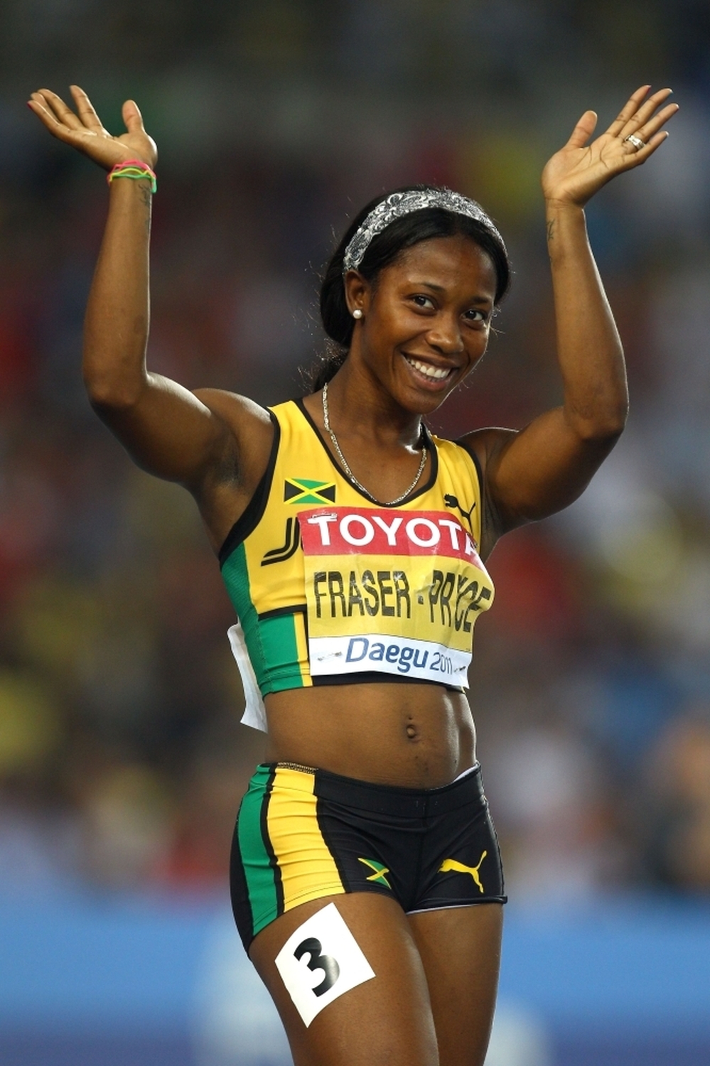 Shelly-Ann Fraser-Pryce waves after competing in the 100-meter semifinal at the World Athletics Championships in South Korea last year. Fraser-Pryce won gold at the 2008 Olympics, and is viewed as a hero by the Jamaican children she sometimes shares a track with.