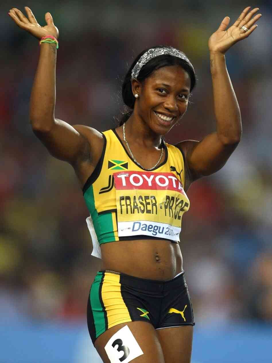 Shelly-Ann Fraser-Pryce waves after competing in the 100-meter semifinal at the World Athletics Championships in South Korea last year. Fraser-Pryce won gold at the 2008 Olympics, and is viewed as a hero by the Jamaican children she sometimes shares a track with.