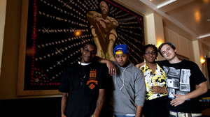 Left to right: Youth Radio participants Evan Childress, 21; Brandon McFarland, 26; Rayana Godfrey, 18; and Skylar Tye Bryant, 18, pose in front of a portrait of Marvin Gaye at the Washington, D.C., restaurant Marvin.