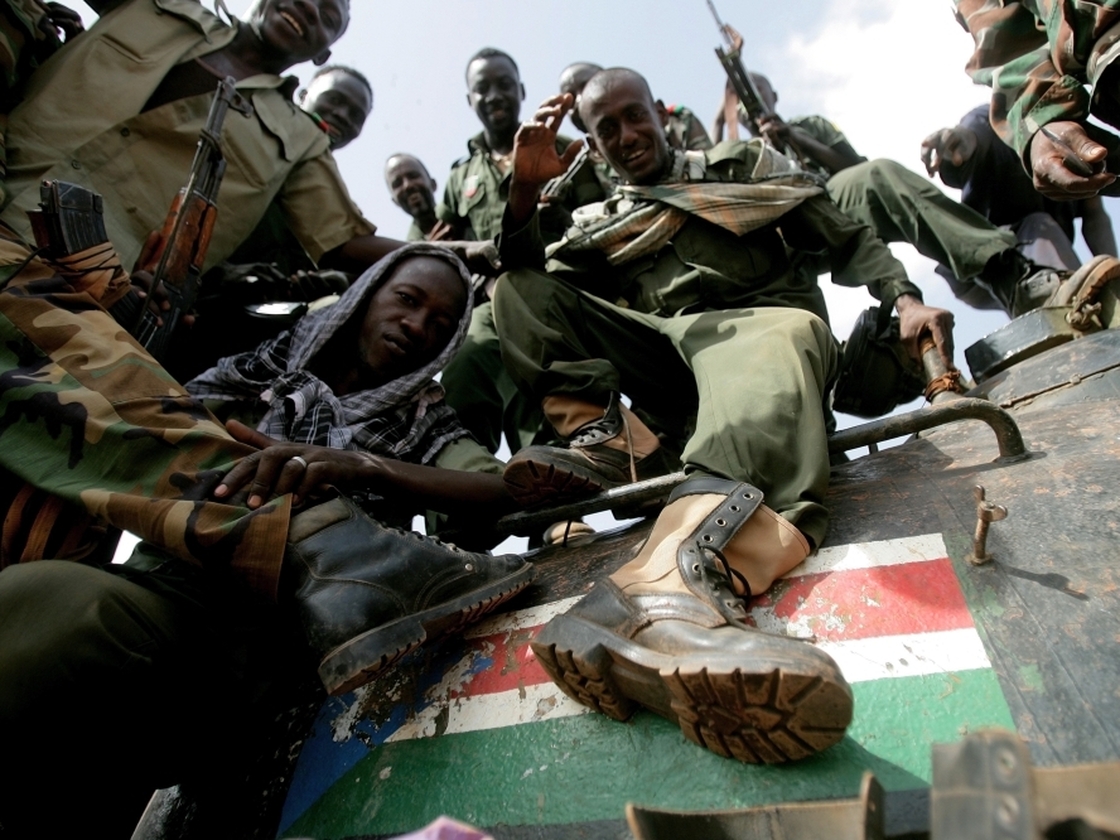 Sudanese soldiers step on the South Sudan flag painted on a seized tank for the Sudanese Peoples Liberation Army in Heglig last month.