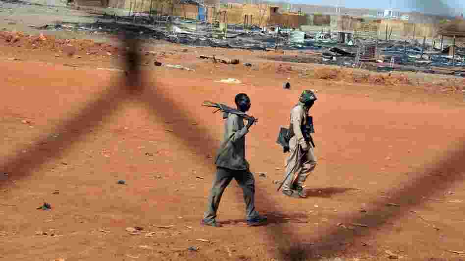 Sudanese soldiers walk in the oil town of Heglig on April 24. South Sudanese forces occupied Heglig last month. The international community called on the South to pull out, which it says it did.