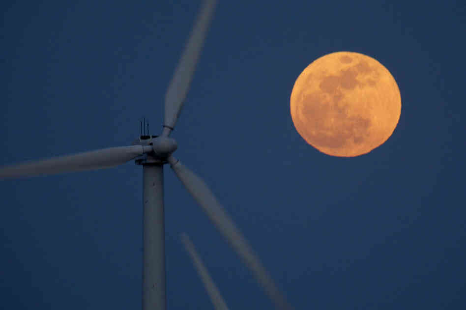 A supermoon rises behind wind turbines Saturday near Palm Springs, Calif. 