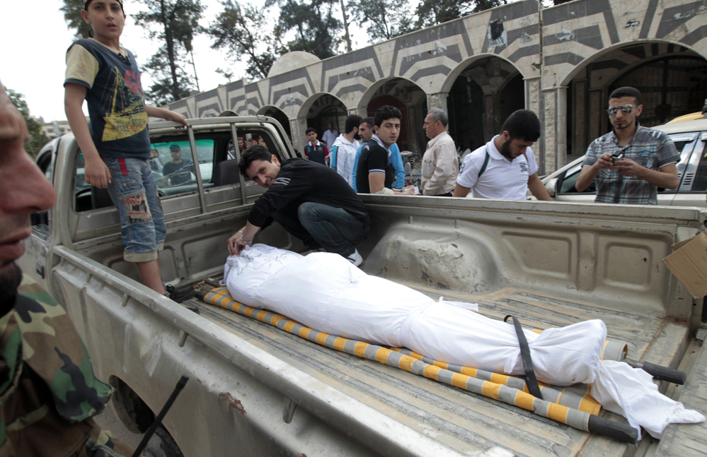 Free Syrian Army members from the al-Faruq Brigade arrive to attend the funeral of one of their comrades at the Khaled Ibn al-Walid mosque in the al-Khalidiyah neighbourhood of the central Syrian city of Homs on Thursday.