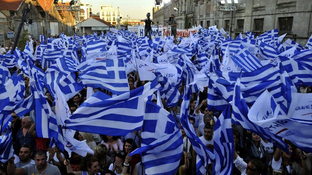 Supporters of the right-wing splinter Independent Greeks party wave flags during an election rally in the northern Greek city of Thessaloniki,  May 2, 2012. Panos Kammenos' party and other anti-bailout parties have made a strong showing in opinion polls ahead of the May 6 general election.