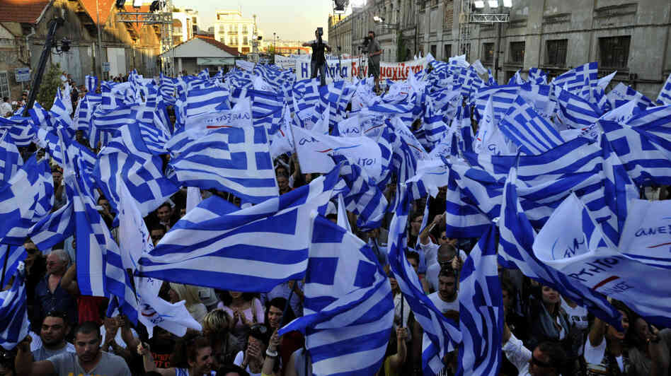 Supporters of the right-wing splinter Independent Greeks party wave flags during an election rally in the northern Greek city of Thessaloniki,  May 2, 2012. Panos Kammenos' party and other anti-bailout parties have made a strong showing in opinion polls ahead of the May 6 general election.