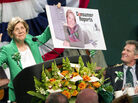 Democratic Senate candidate Elizabeth Warren holds up a poster of herself as Sen. Scott Brown, R-Mass., looks on during the annual St. Patrick's Day Breakfast in Boston on March 18. A civility pledge between the candidates has kept attack ads largely on the sidelines in their race. Democratic Senate candidate Elizabeth Warren holds up a poster of herself as Sen. Scott Brown, R-Mass., looks on during the annual St. Patrick's Day Breakfast in Boston on March 18. A civility pledge between the candidates has kept attack ads largely on the sidelines in their race.