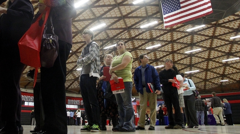 People wait in a line at a job fair on April 10, 2012, in Gresham, Ore. Employment grew by 115,000 last month, but the unemployment rate dip was likely due to people leaving the workforce rather than people getting hired, analysts say.