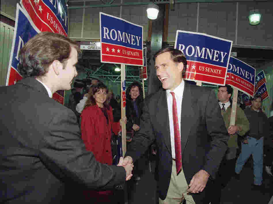Then a Republican candidate for the U.S. Senate, Mitt Romney shakes the hand of a commuter while campaigning at North Station in Boston on Nov. 7, 1994.