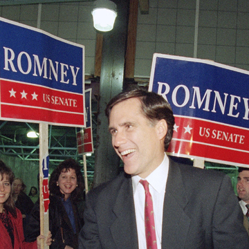 Then a Republican candidate for the U.S. Senate, Mitt Romney shakes the hand of a commuter while campaigning at North Station in Boston on Nov. 7, 1994.