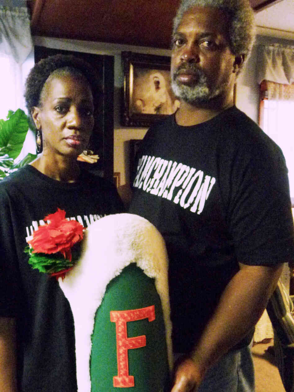 Pam and Robert Champion hold their son's drum major hat from Florida Agricultural and Mechanical University. Robert Champion Jr. died after a hazing incident in November.
