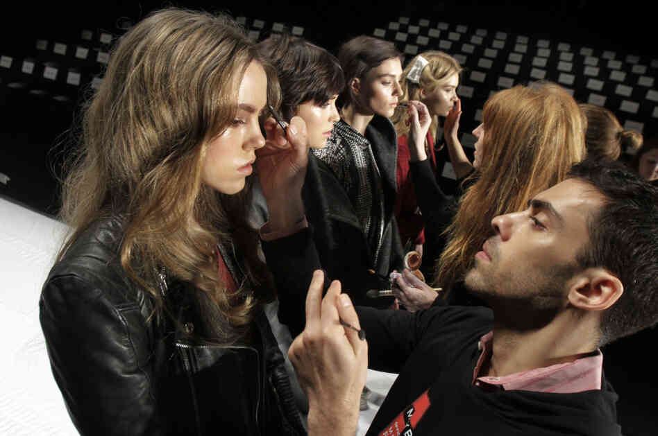 In this Feb. 15, 2012, file photo, models have their make-up finalized under runway light before the J. Mendel Fall 2012 collection is modeled during Fashion Week, in New York.