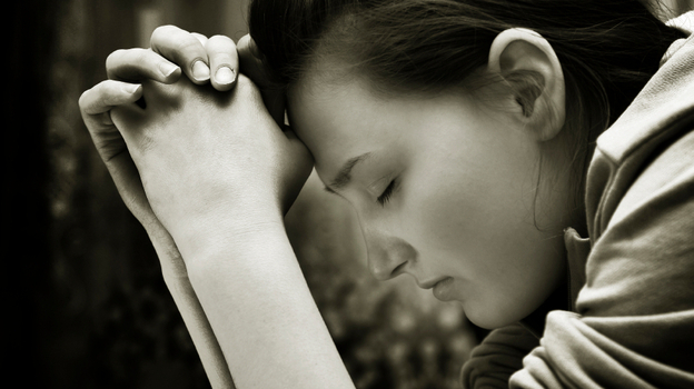 Young girl praying.